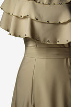 Beige dress with a layered ruffle top and studded details on a white background