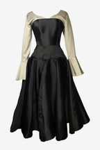 Black dress with beige long sleeves on a white background