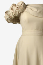 Beige dress with floral shoulder details on a white background