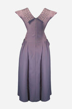 Purple dress with decorative neckline on a light gray background