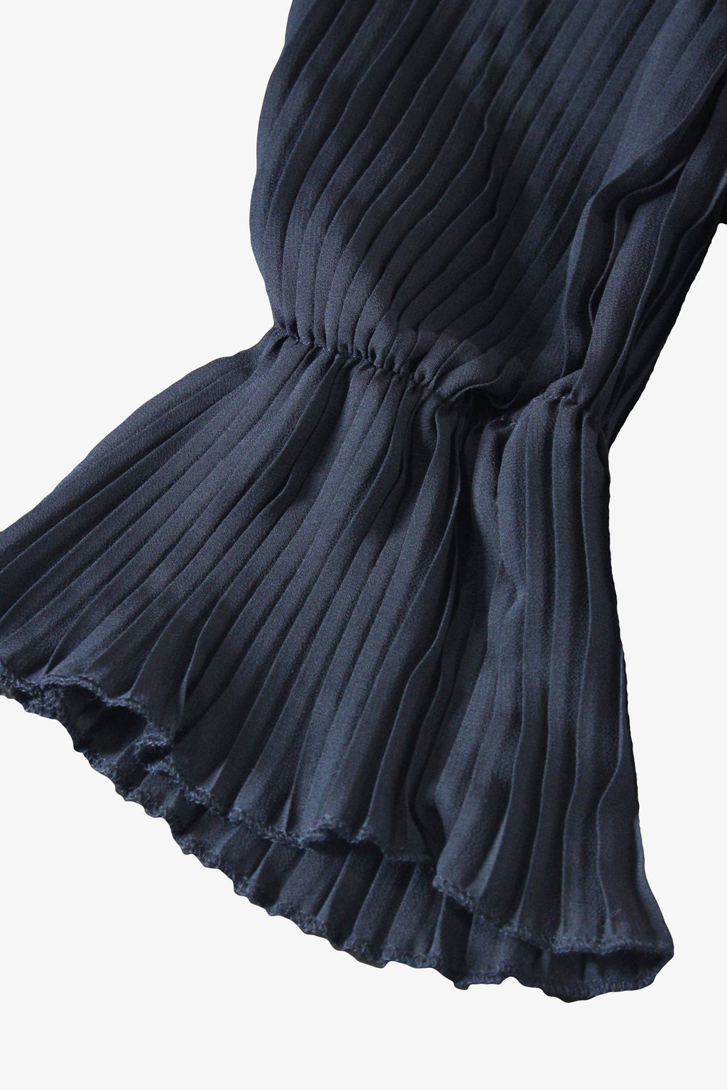 Dark pleated dress on a white background