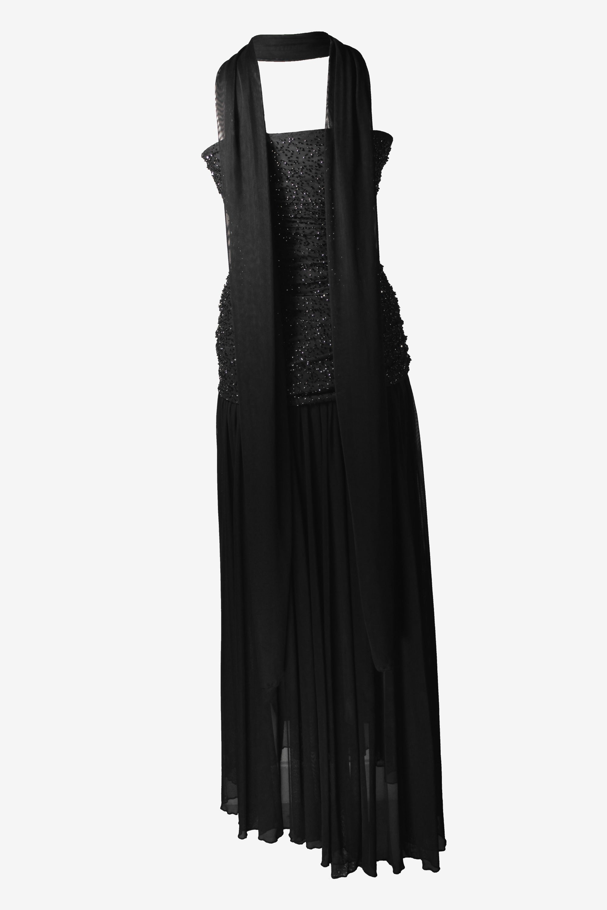 Black evening gown with sheer overlay on a white background