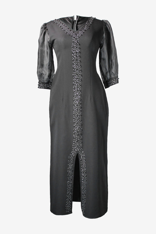 Black dress with silver embellishments on a white background