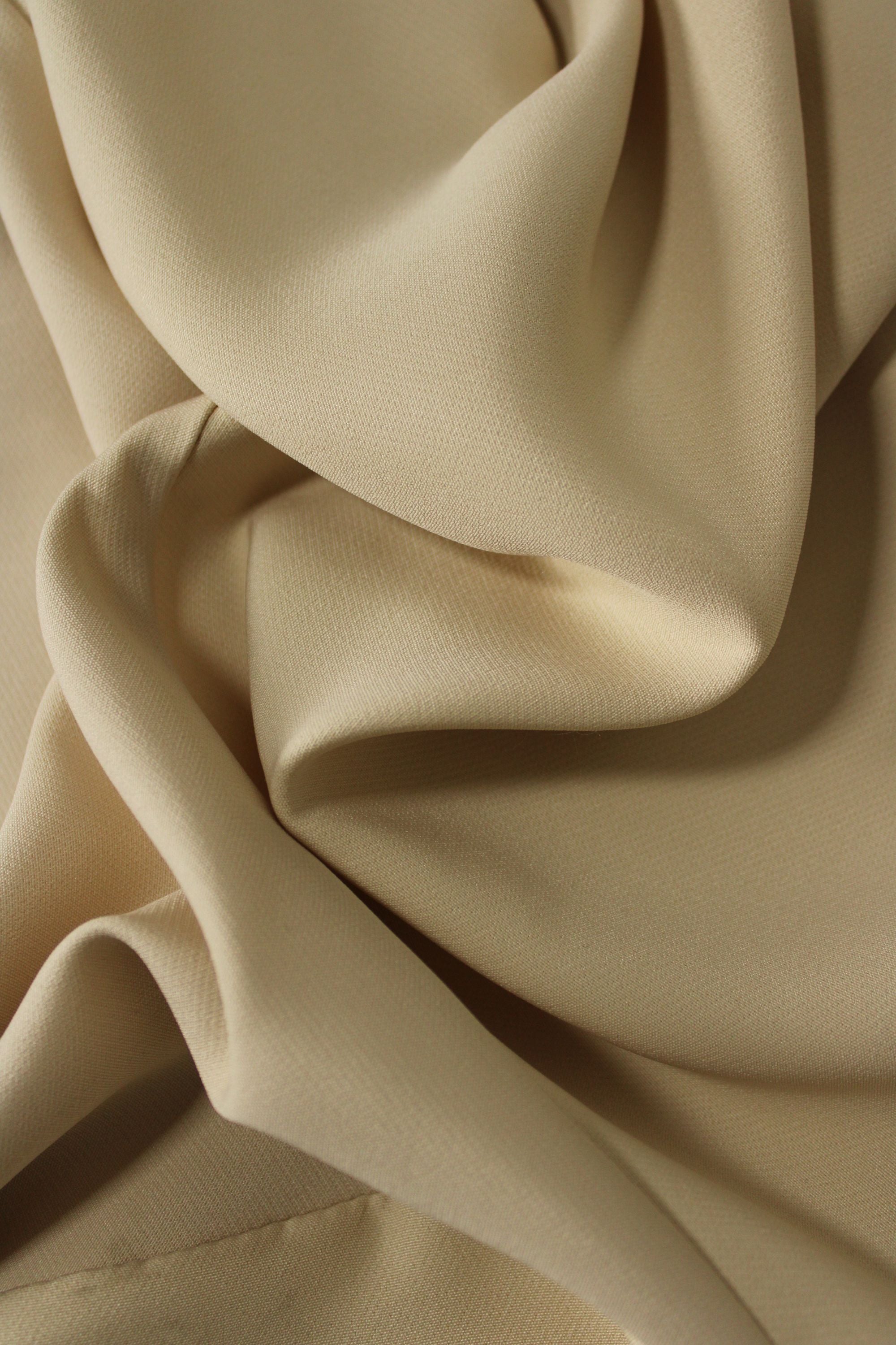 Close-up of beige fabric with folds
