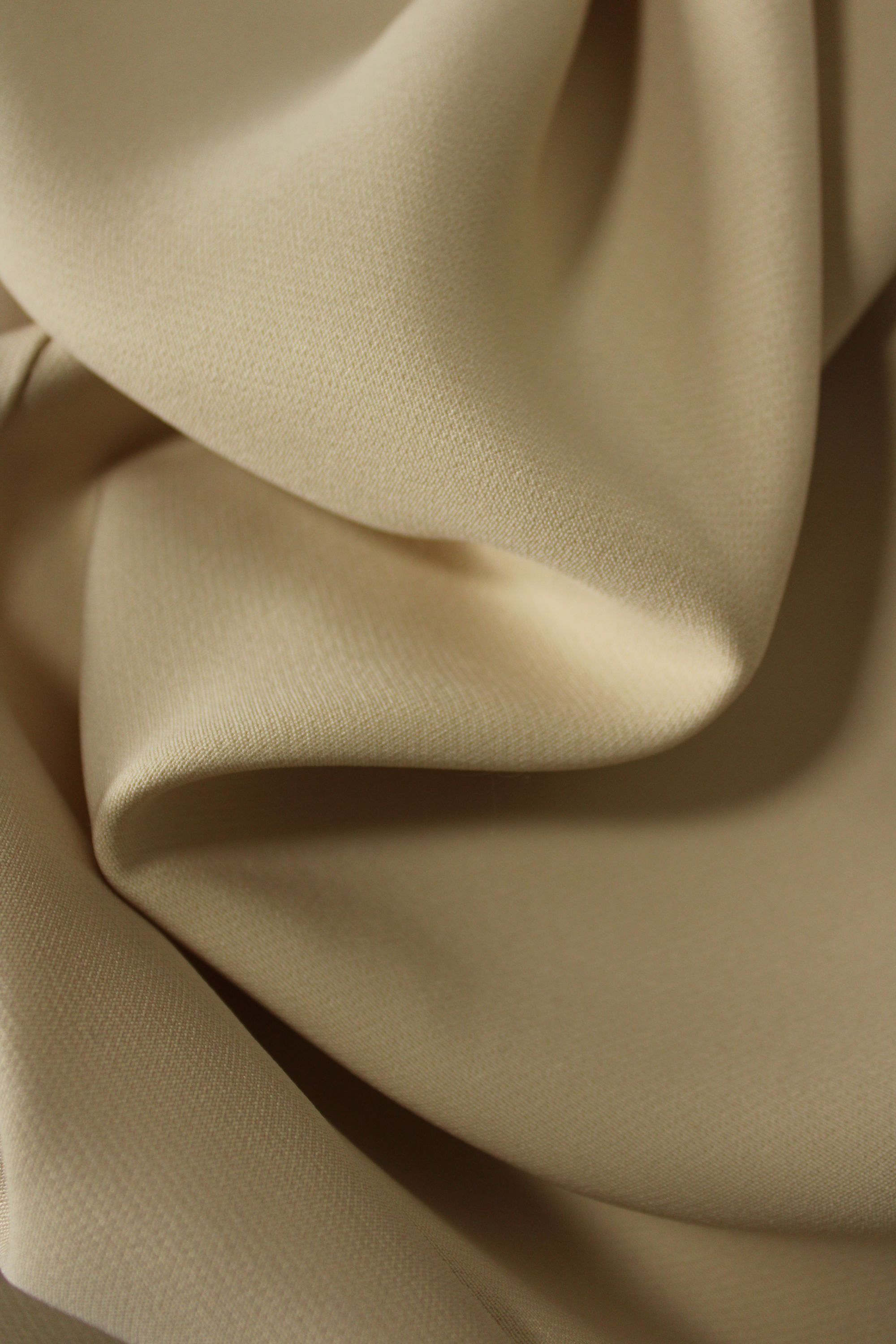 Close-up of beige fabric with folds