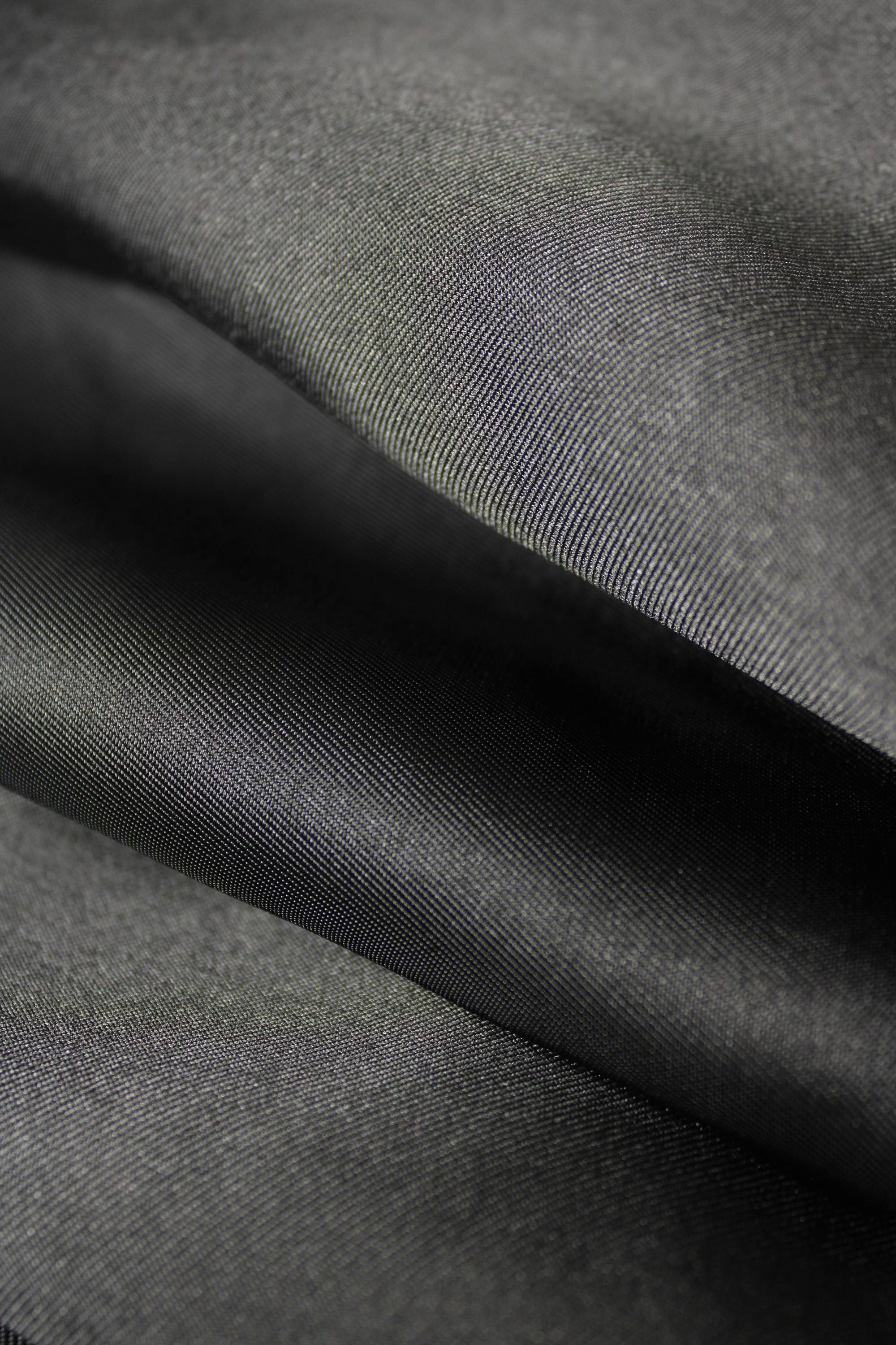 Close-up of  black mikado fabric with visible texture