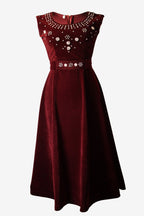 red dress with floral embellishments on a white background