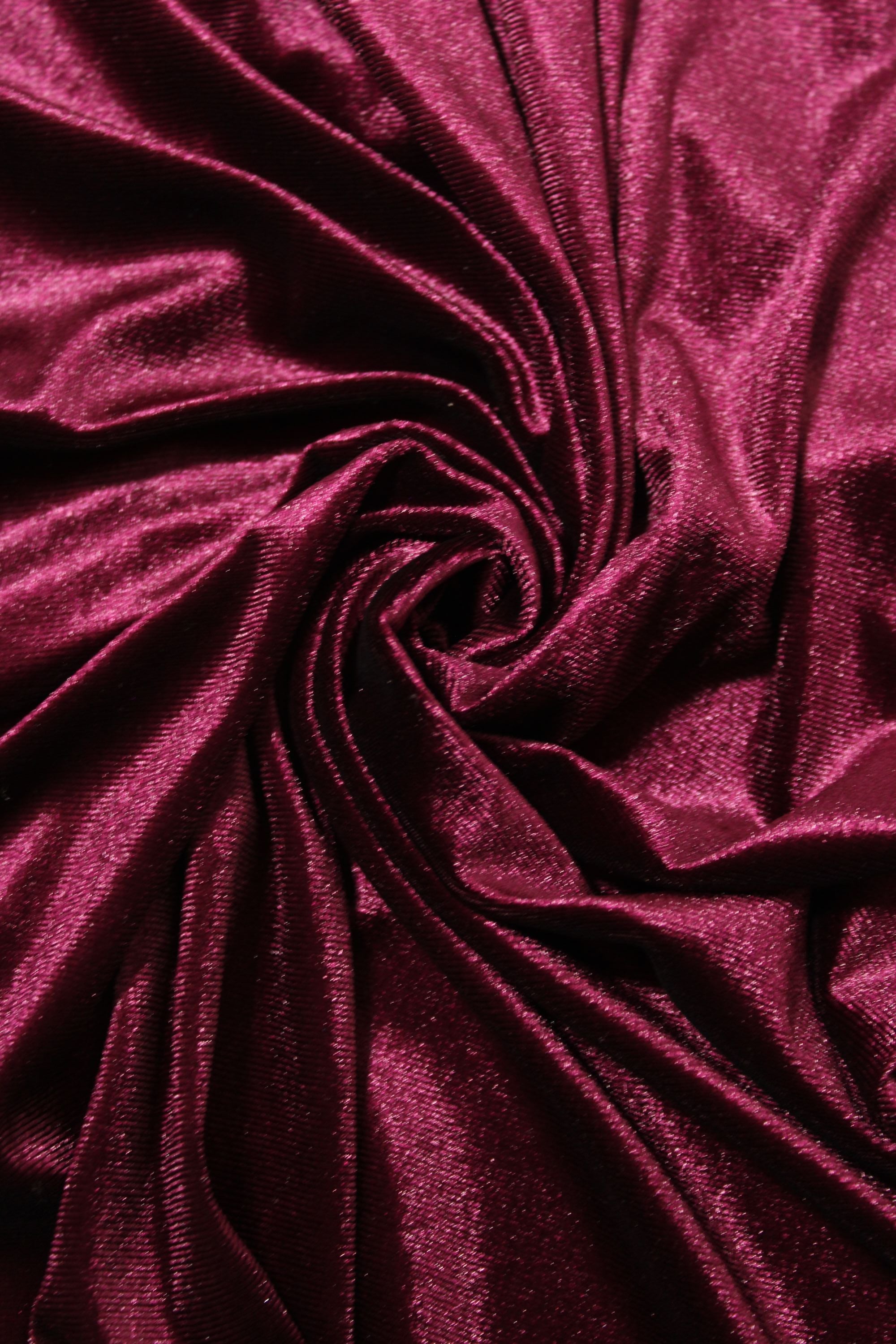 Close-up of maroon velvet fabric with folds