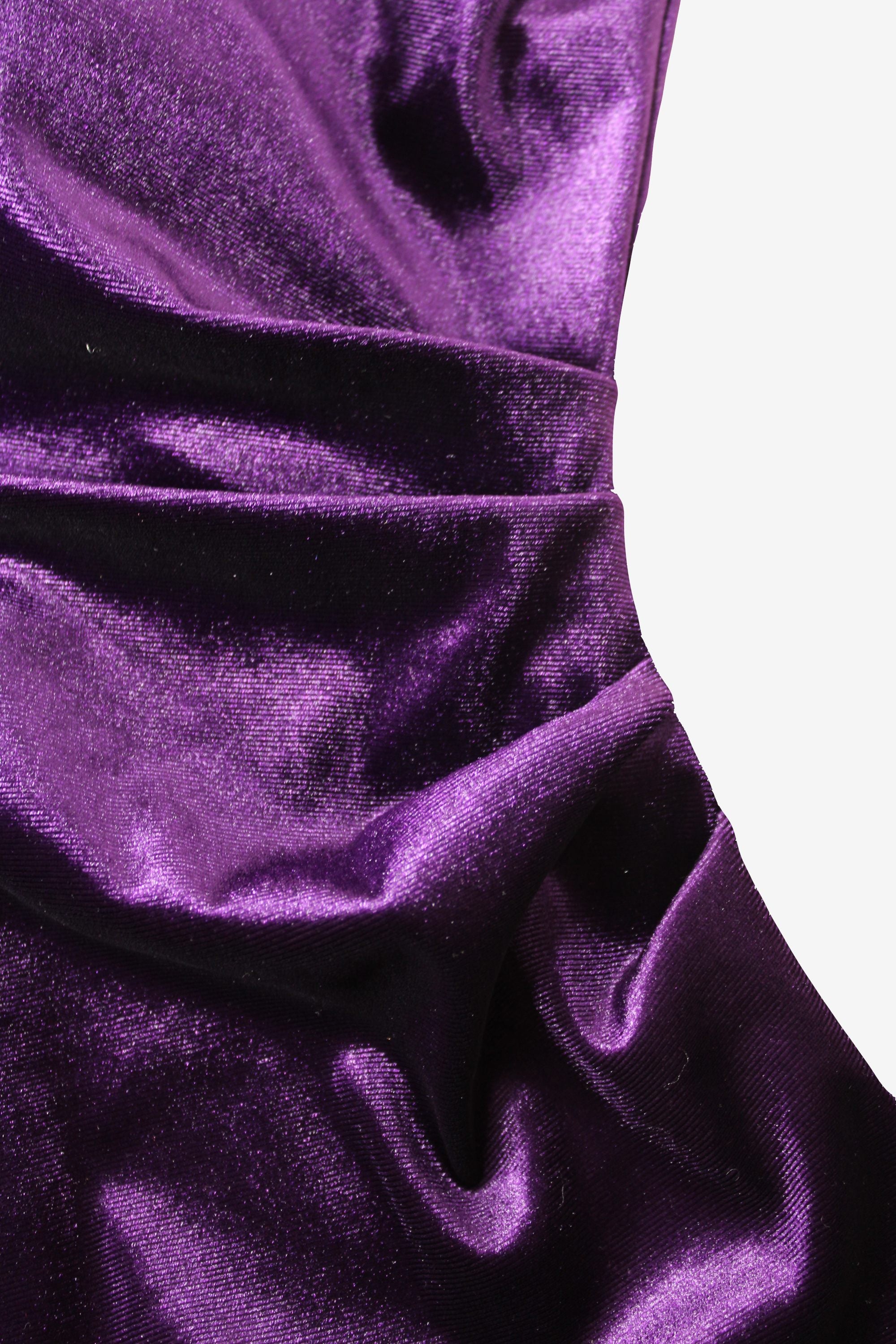 Close-up of purple velvet fabric with folds on a white background