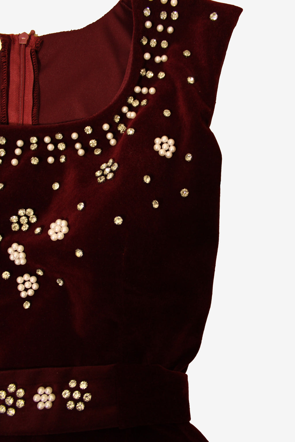 red top with gold bead embellishments on a white background