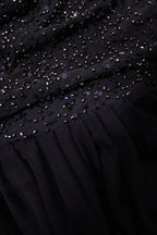Close-up of a blue dress with bead detailing