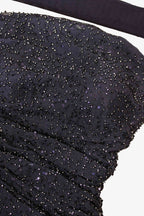 Close-up of a blue beaded fabric with a white background