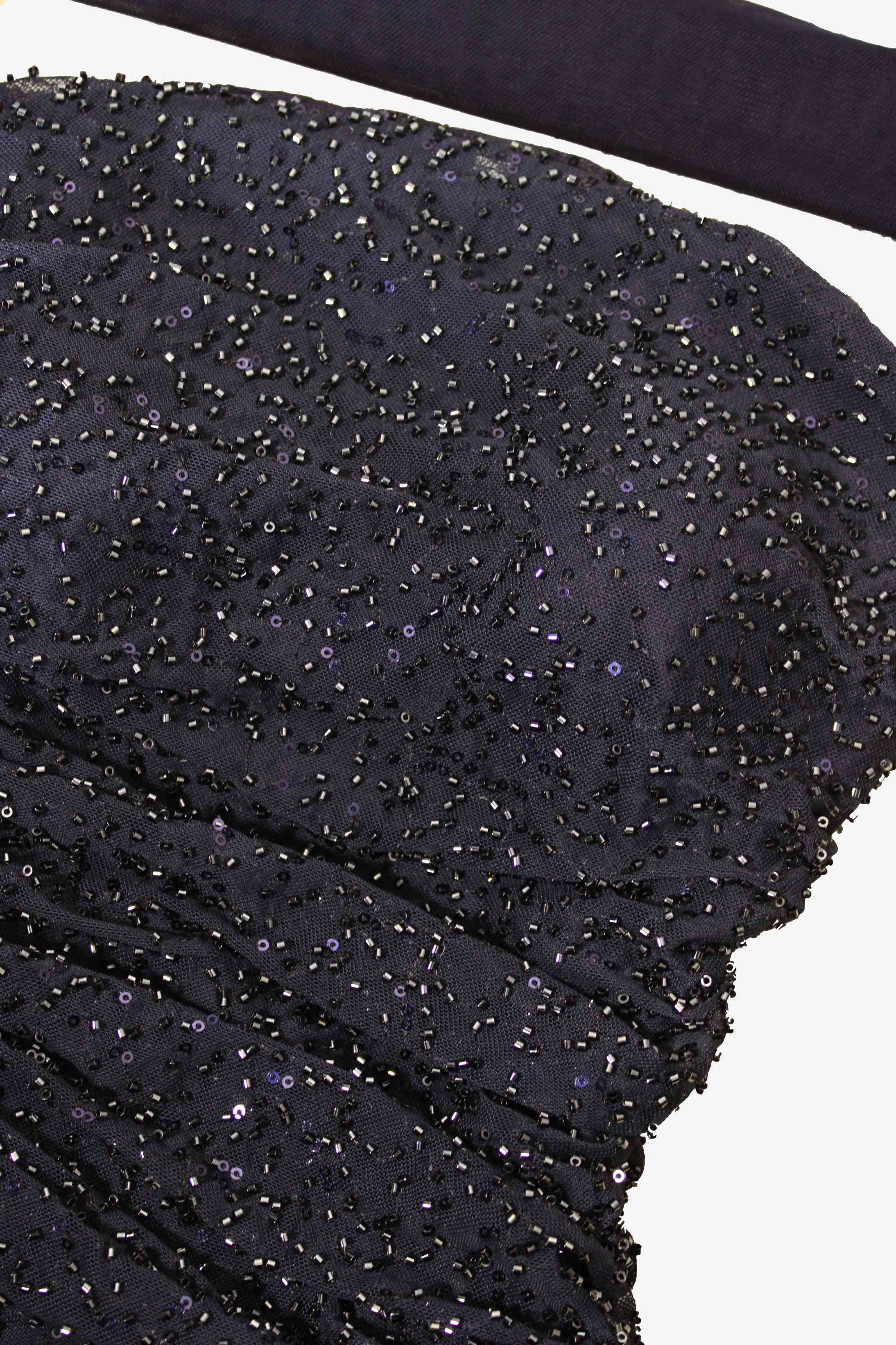 Close-up of a blue beaded fabric with a white background