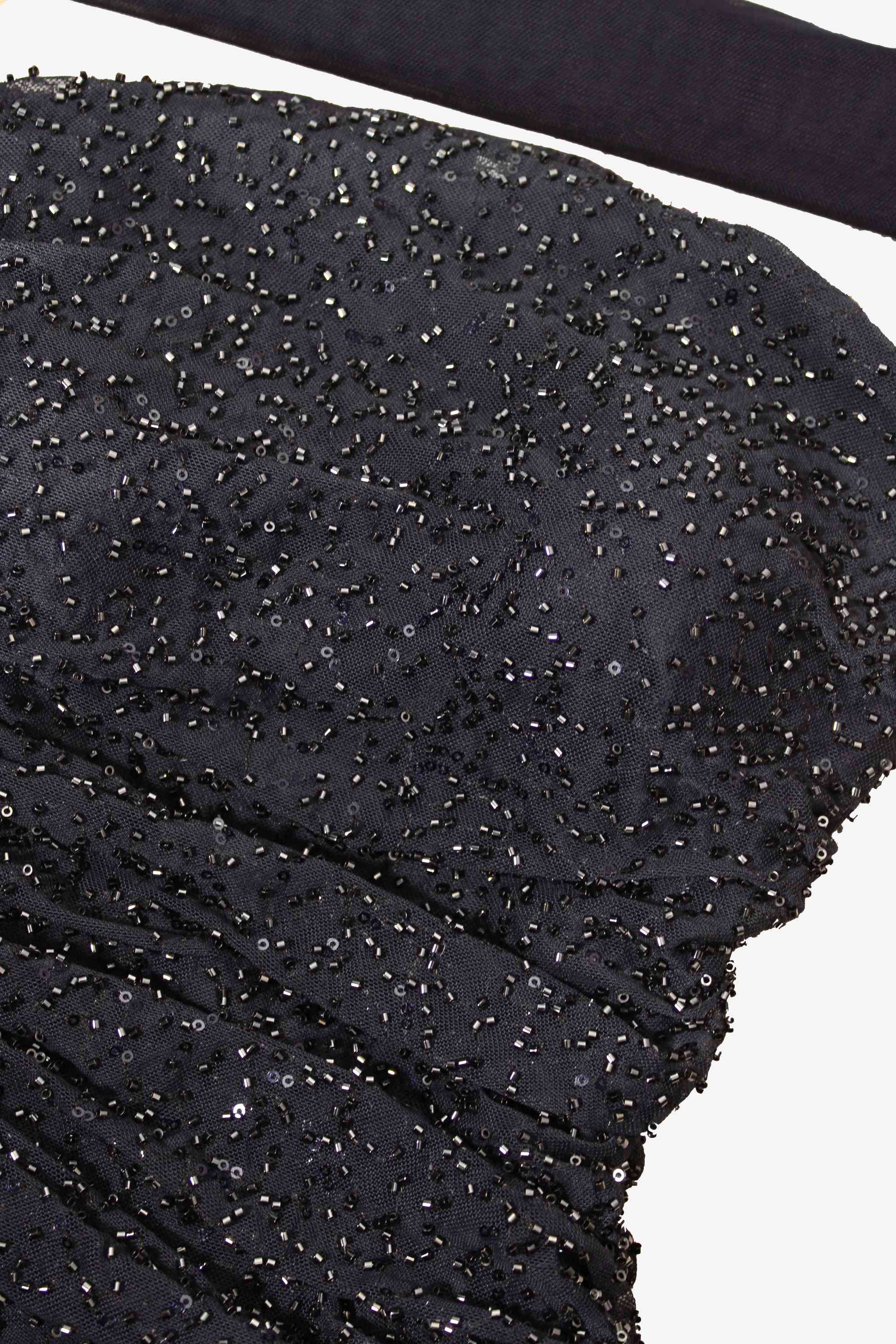 Close-up of black sequined fabric with a white background