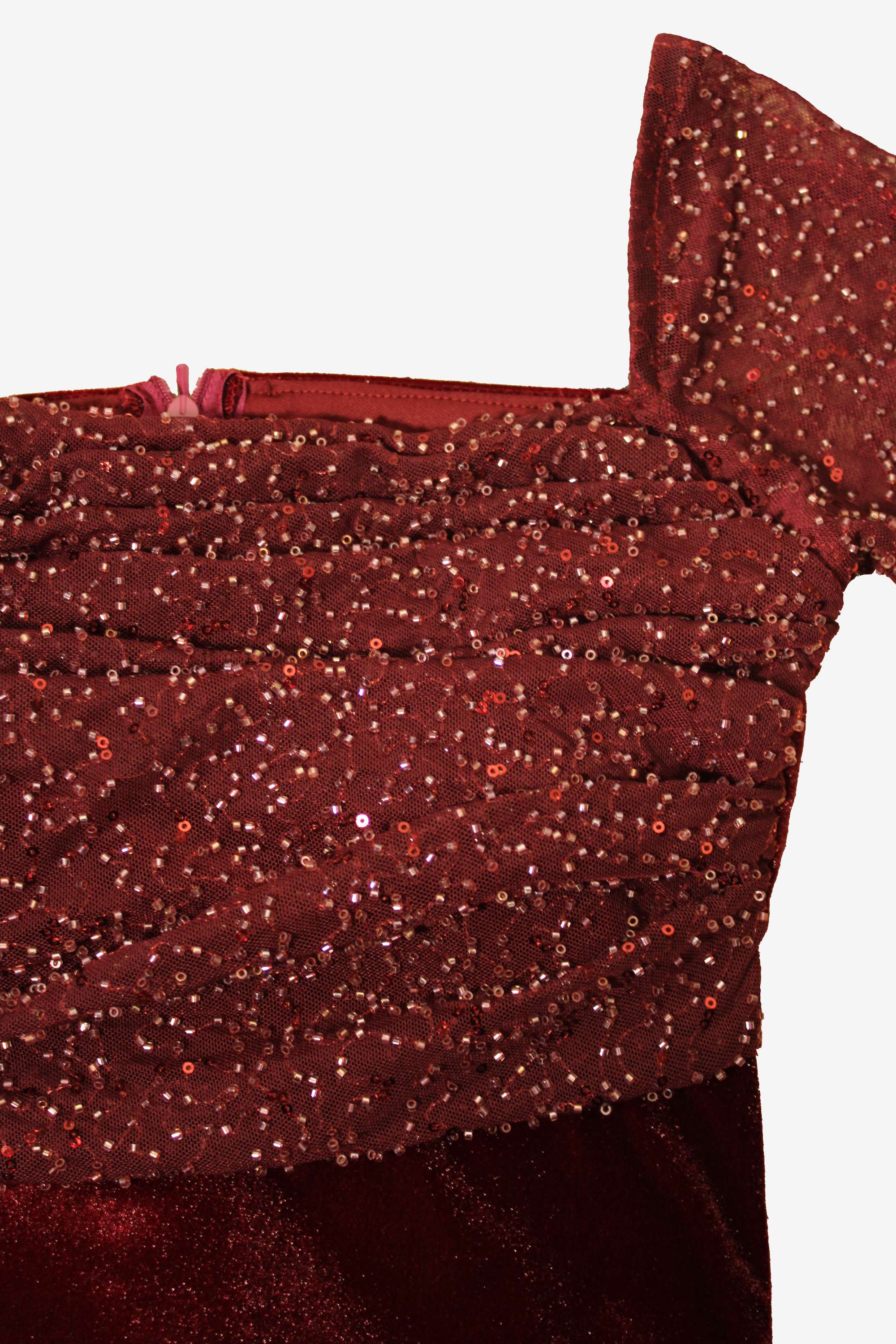 Close-up of a red glittery fabric with a white background