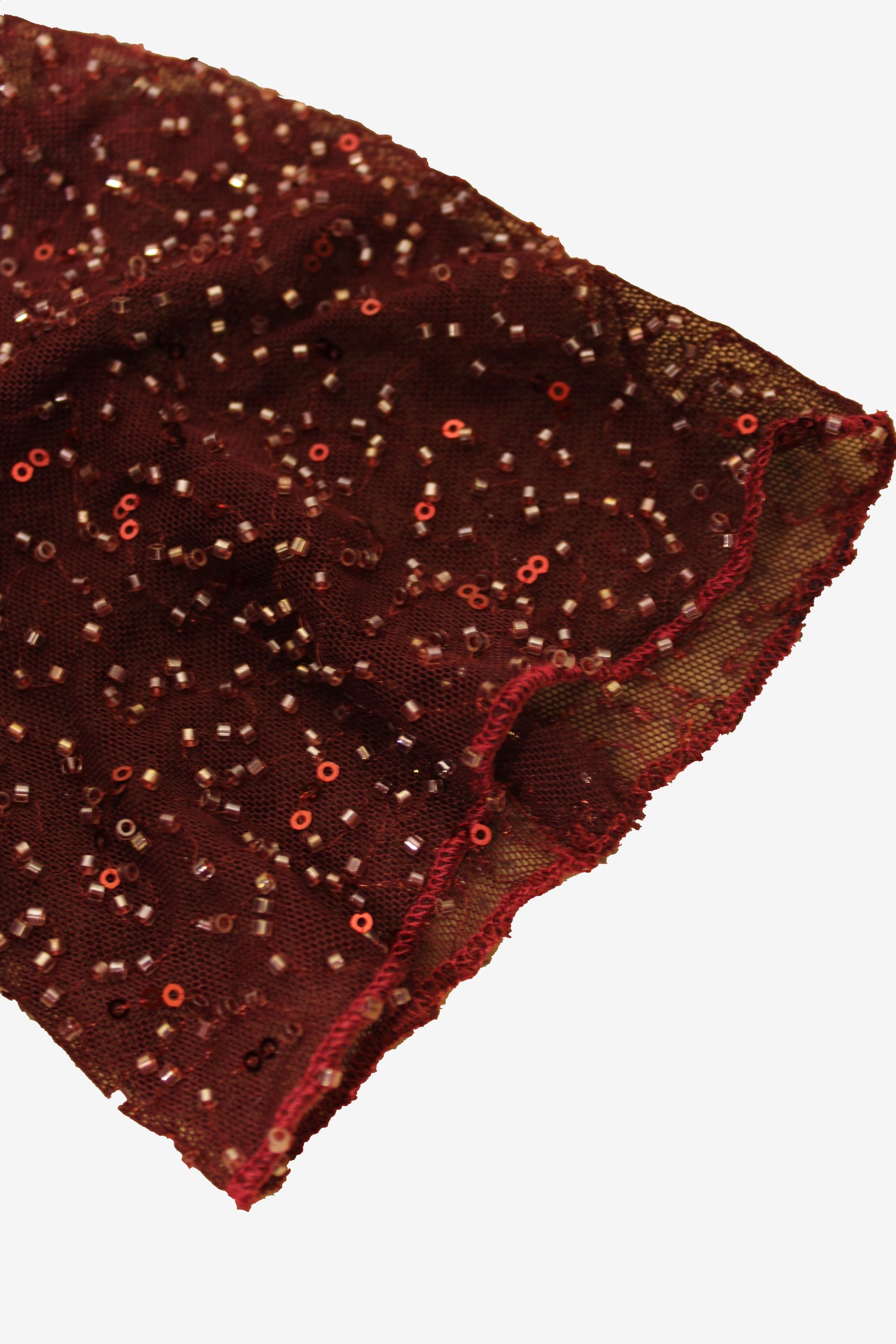Brown fabric with red sequins on a white background