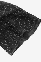 Black fabric with small white patterns on a white background