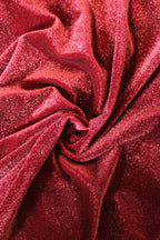 Close-up of red glittery fabric with folds