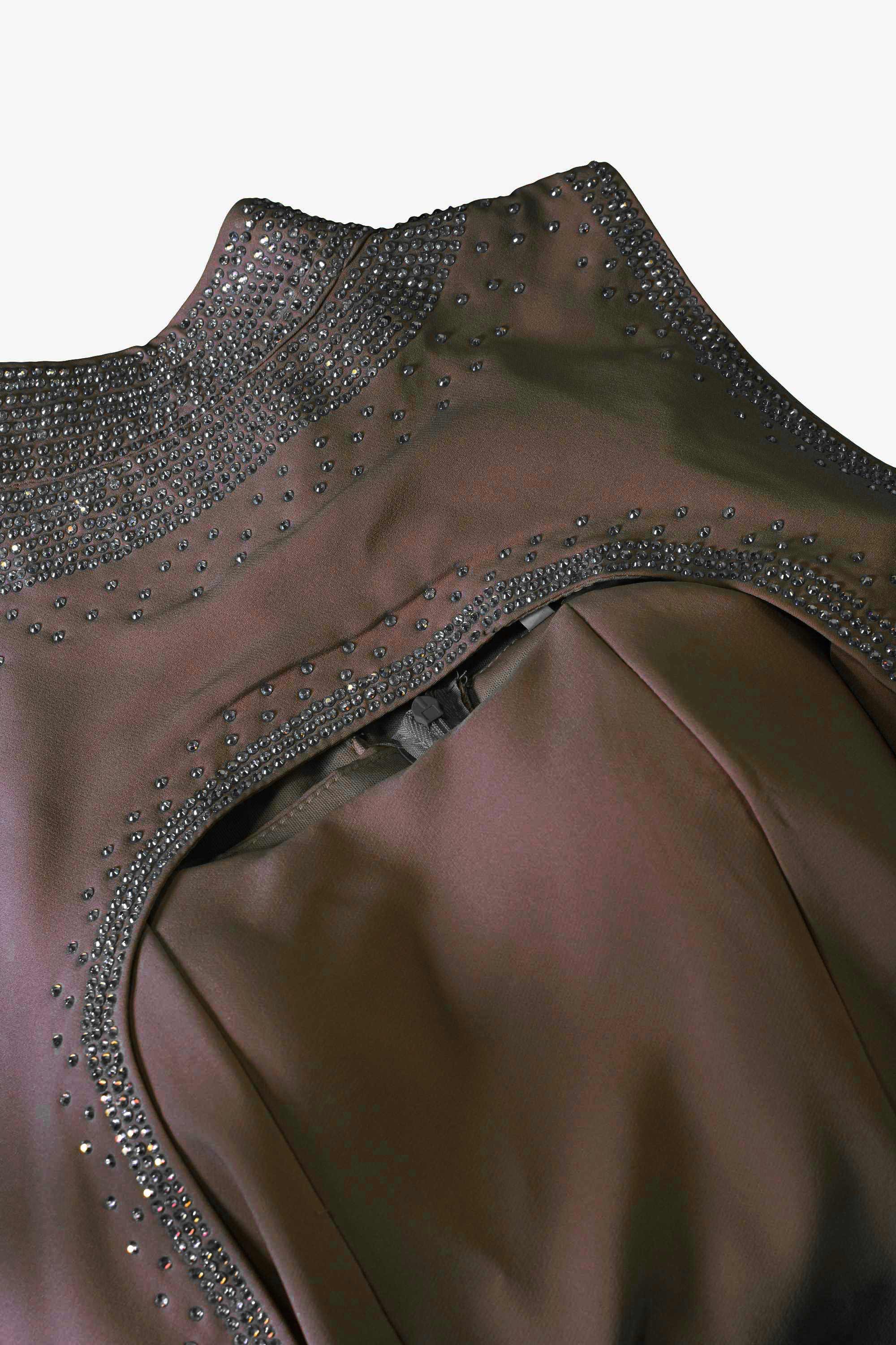 Brown dress with decorative embellishments on a white background