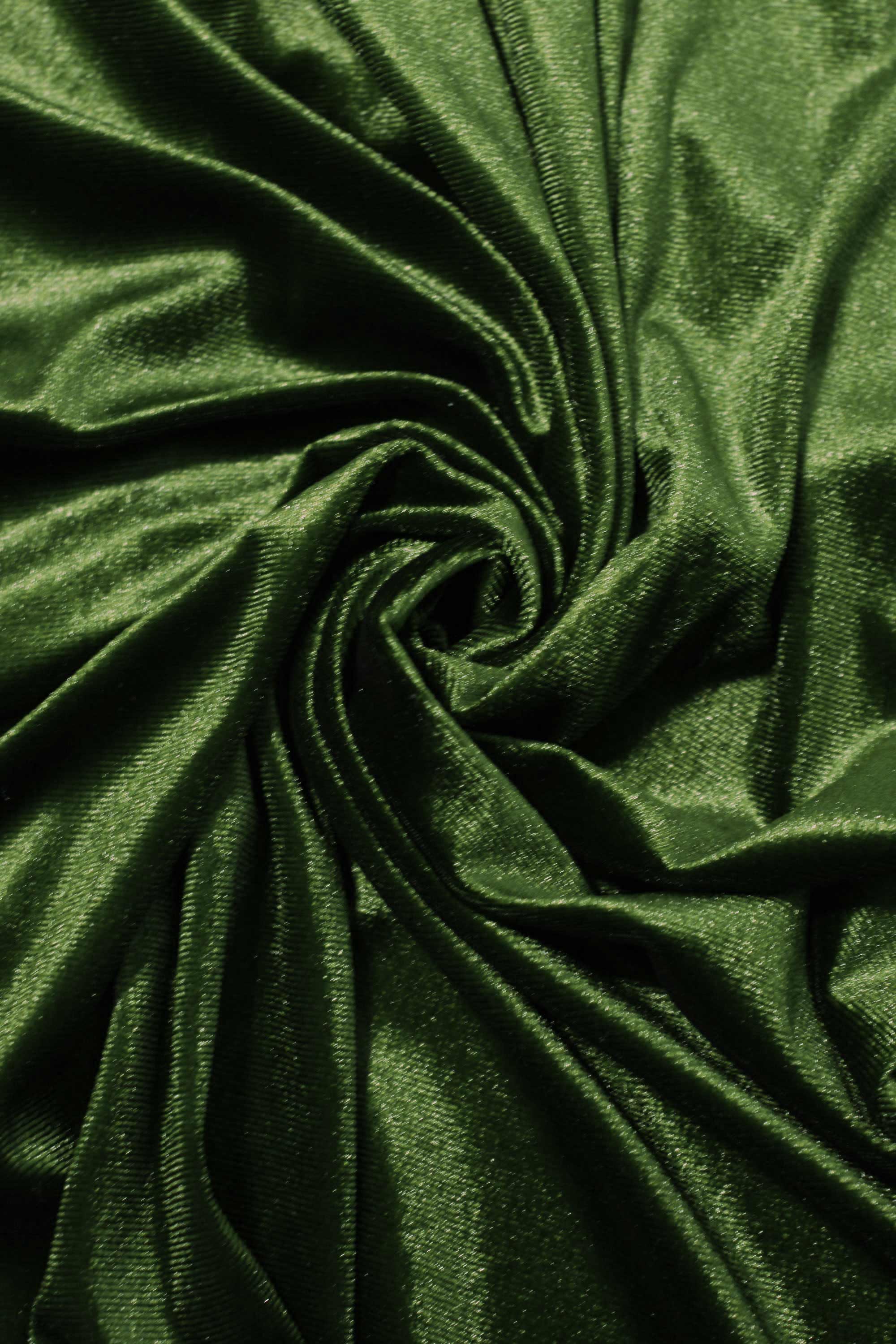 Close-up of dark green velvet fabric with folds