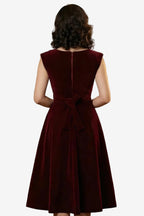 Burgundy velvet dress with a belt on a white background