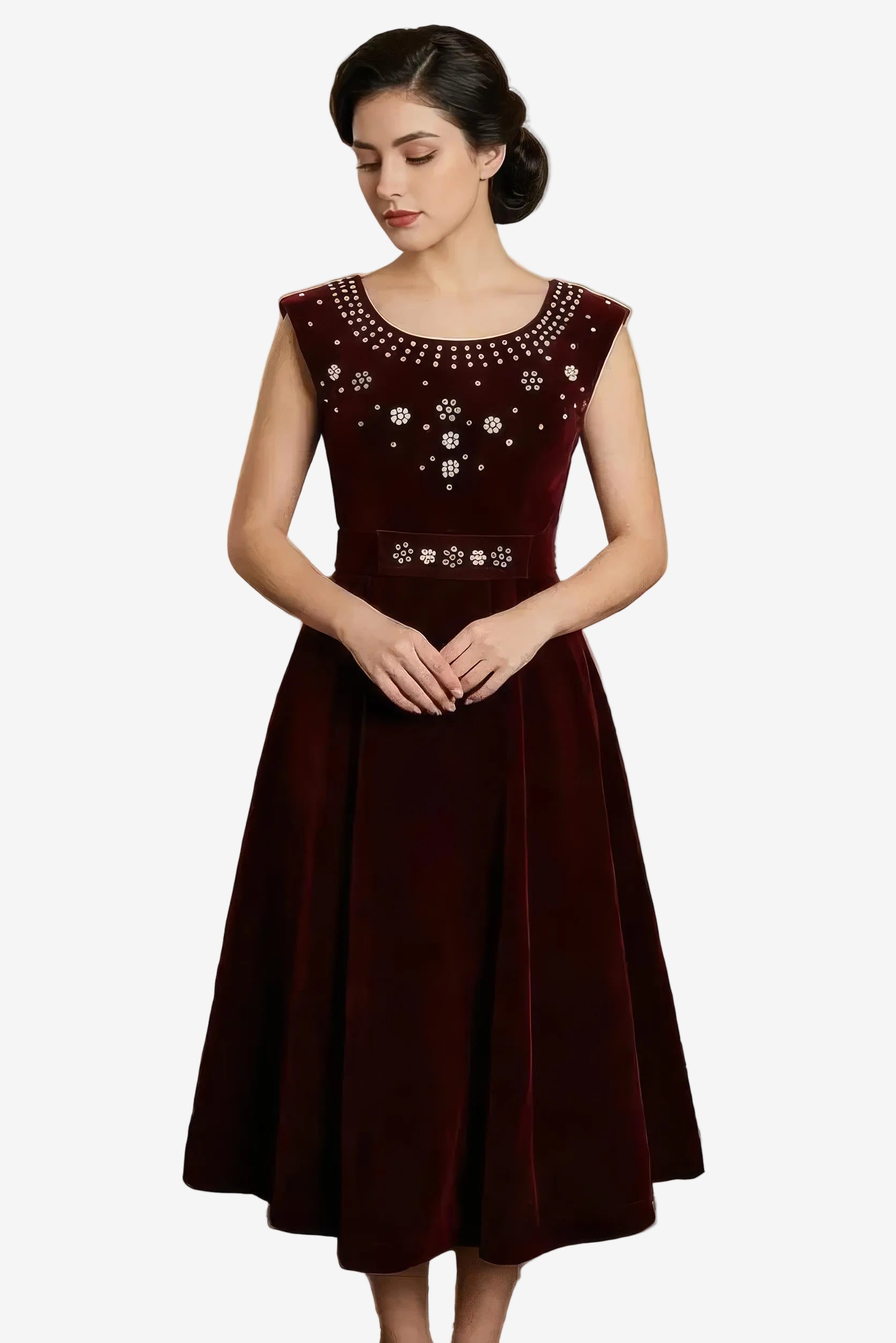 Woman wearing a maroon dress with floral embellishments on a white background
