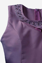 Purple dress with embellished neckline on a white background
