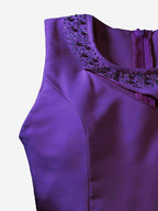 Purple dress with embellished neckline on a white background